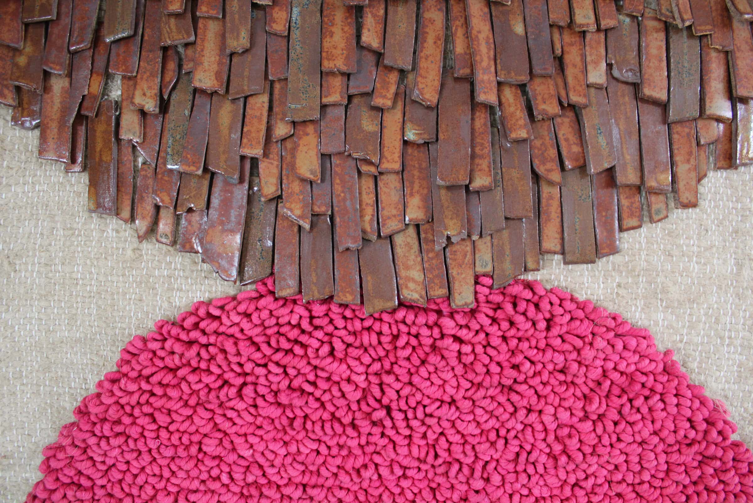 Closeup of a pink and brown rug.