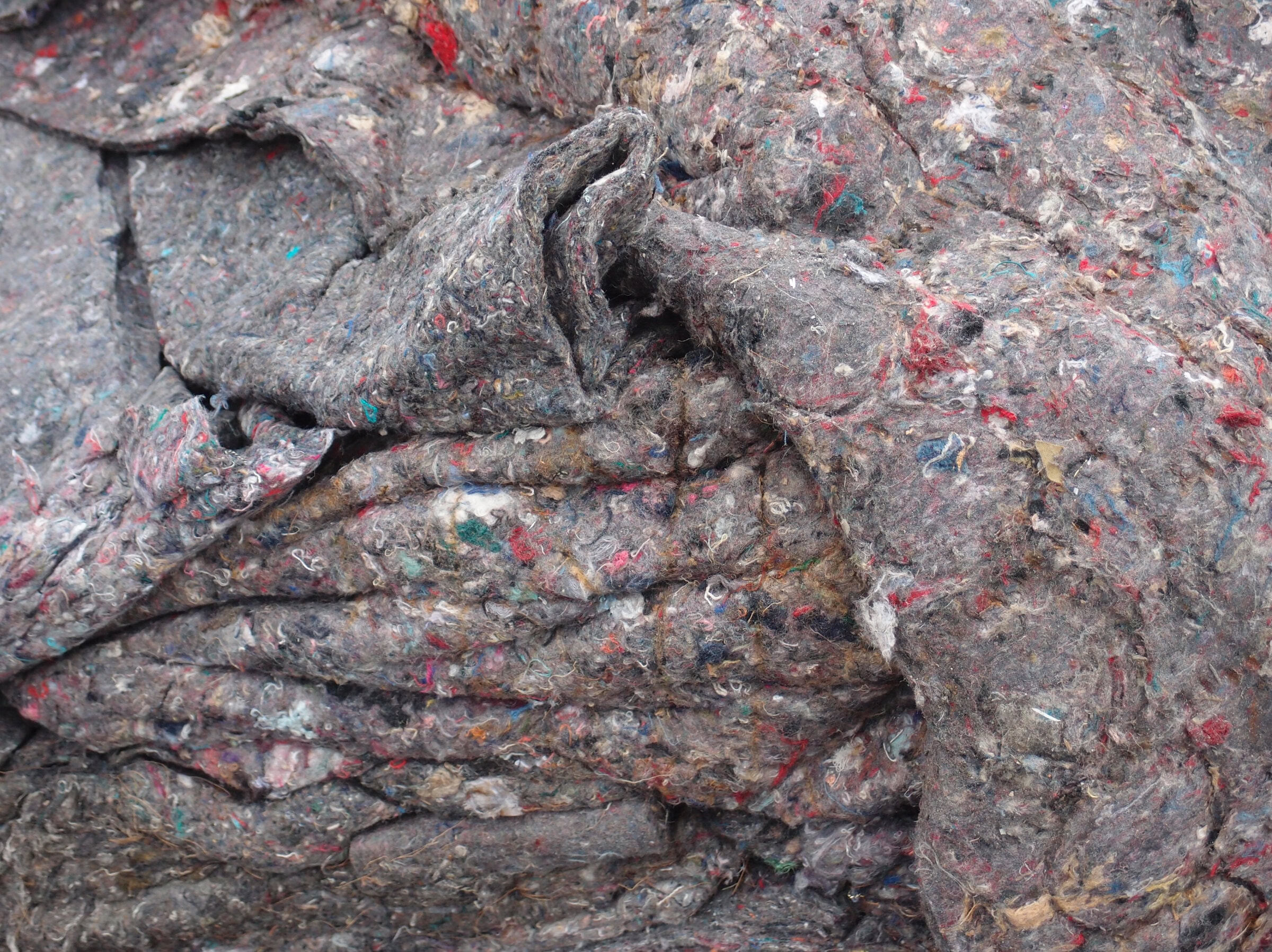 Close-up of gray and colorful fabric scraps.