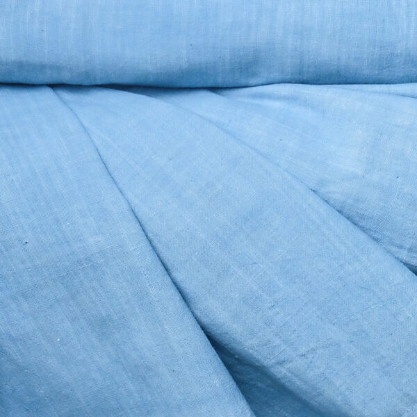 Image of a roll of sky blue organic handspun cotton fabric draped