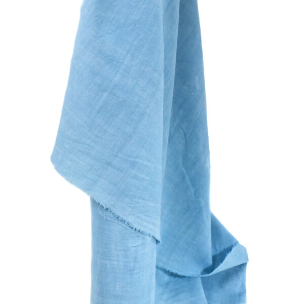 an image of sky blue handspun organic cotton fabric hanging