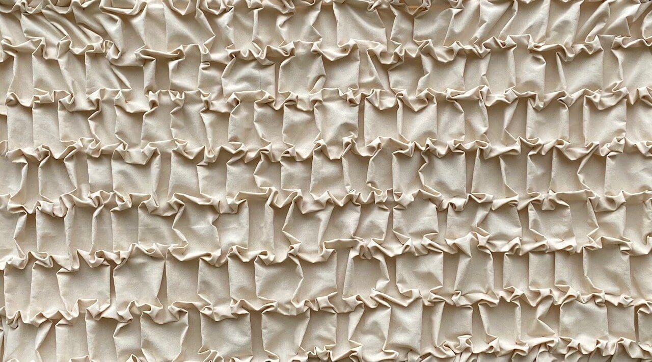 Beige fabric with ruffled texture.