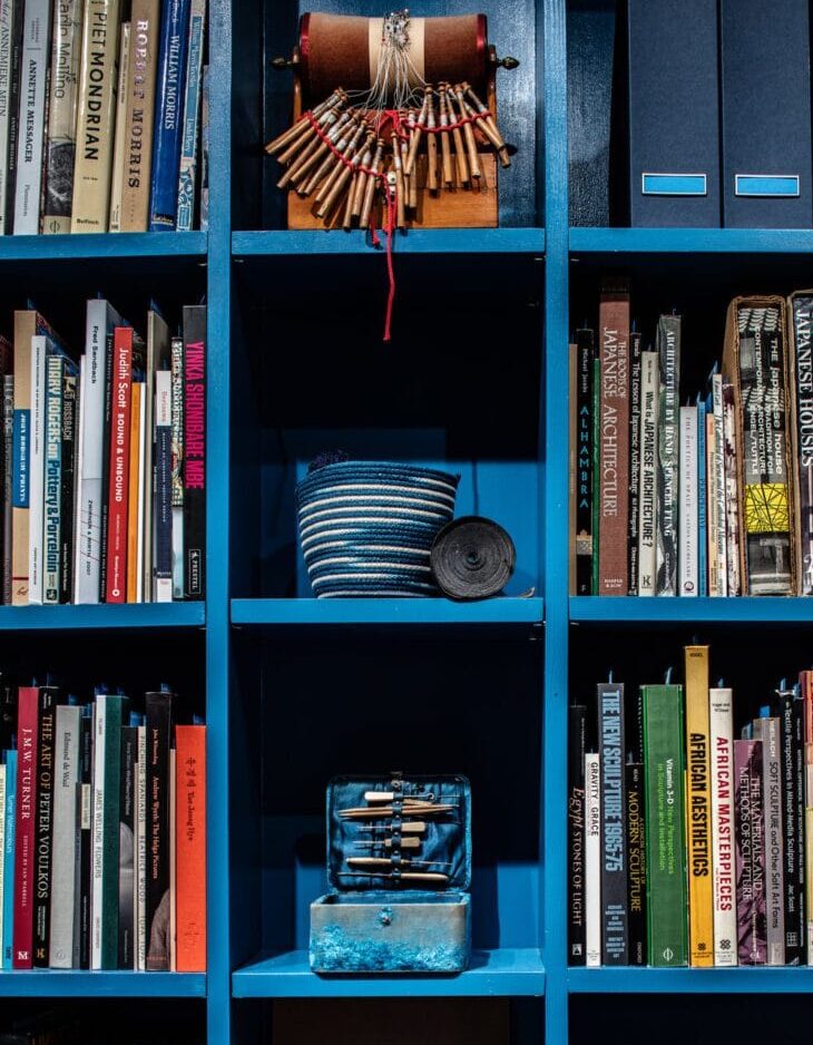 Blue bookshelf with art and design books.