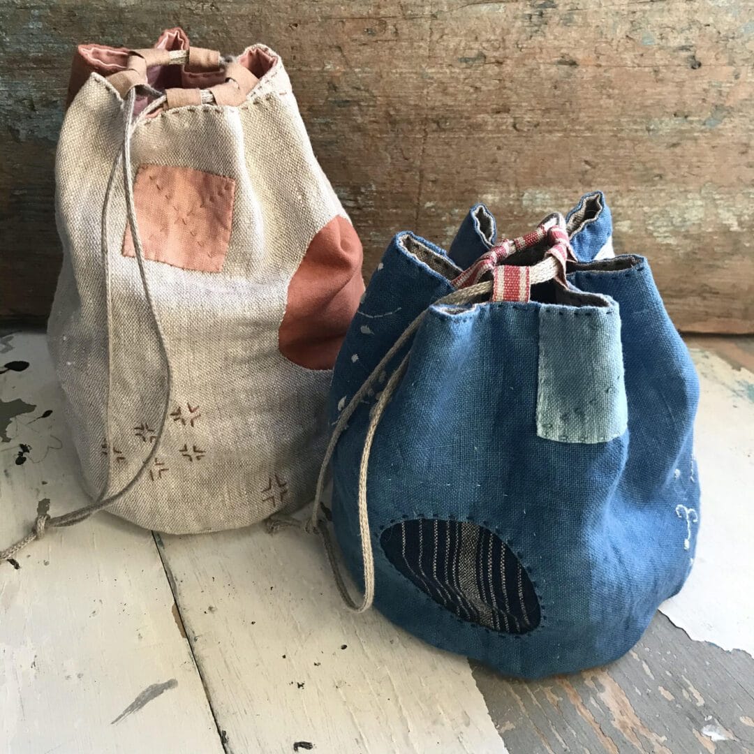 Two handmade fabric drawstring bags.