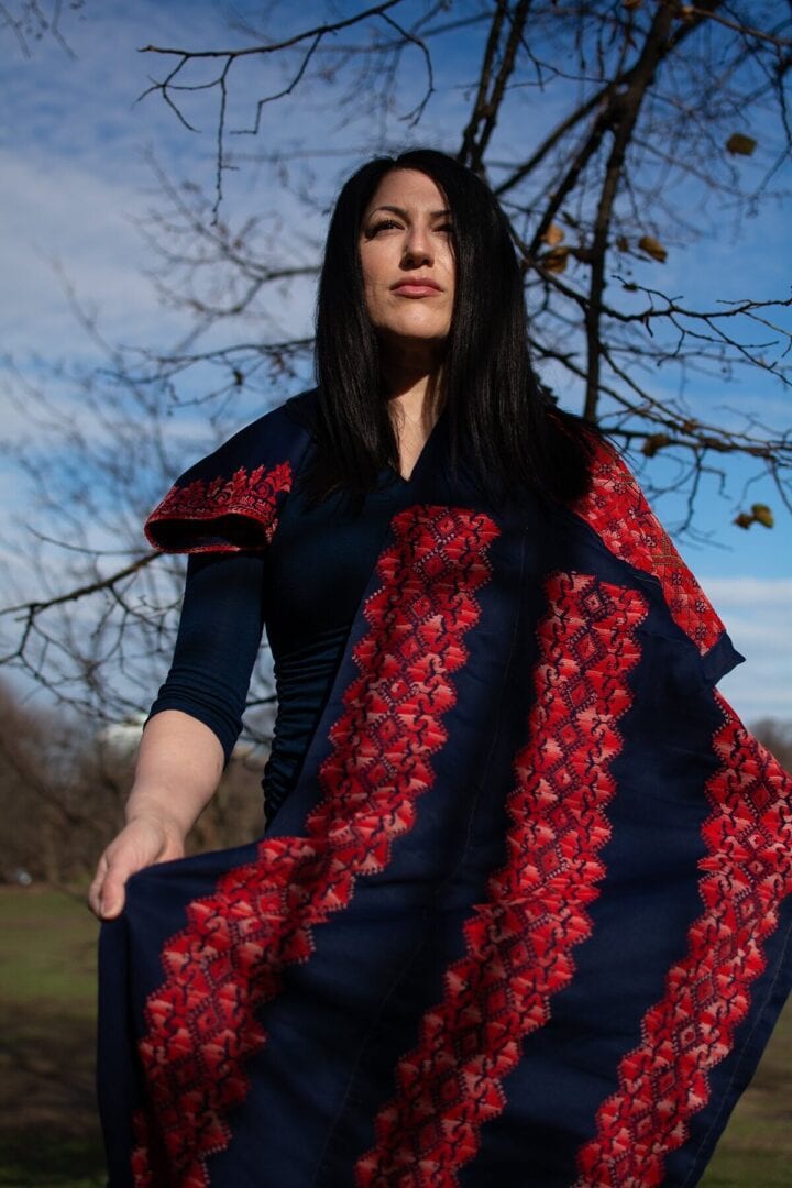 Woman in blue and red patterned dress.