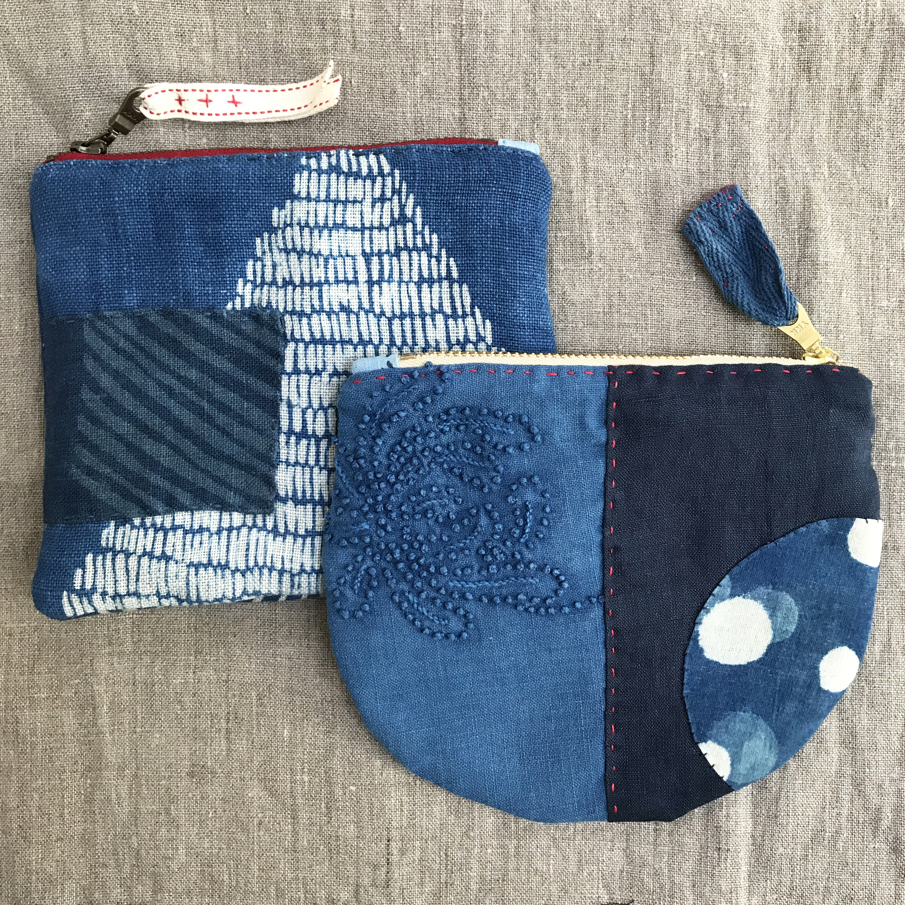 Two blue fabric zippered pouches.