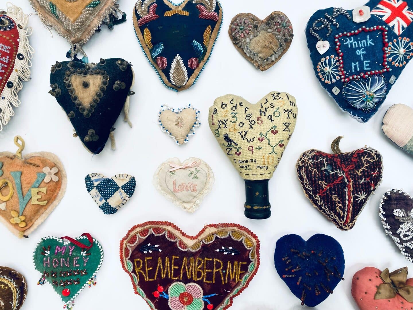 Embroidered fabric heart pincushions.