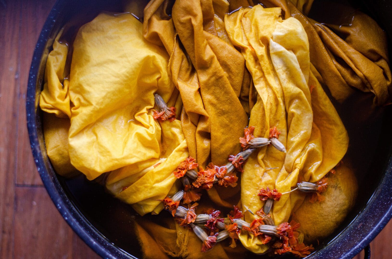 Yellow fabric dye with flowers in a pot.