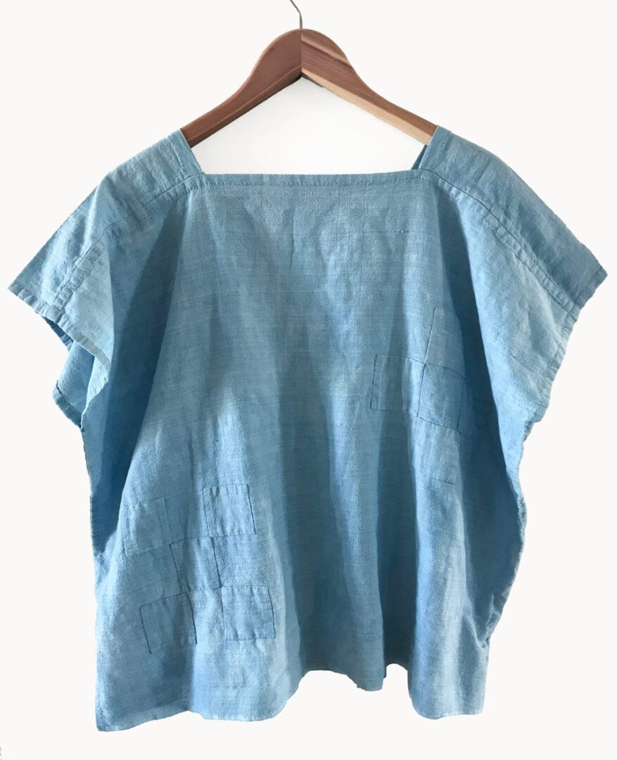 Light blue linen top with patchwork details.