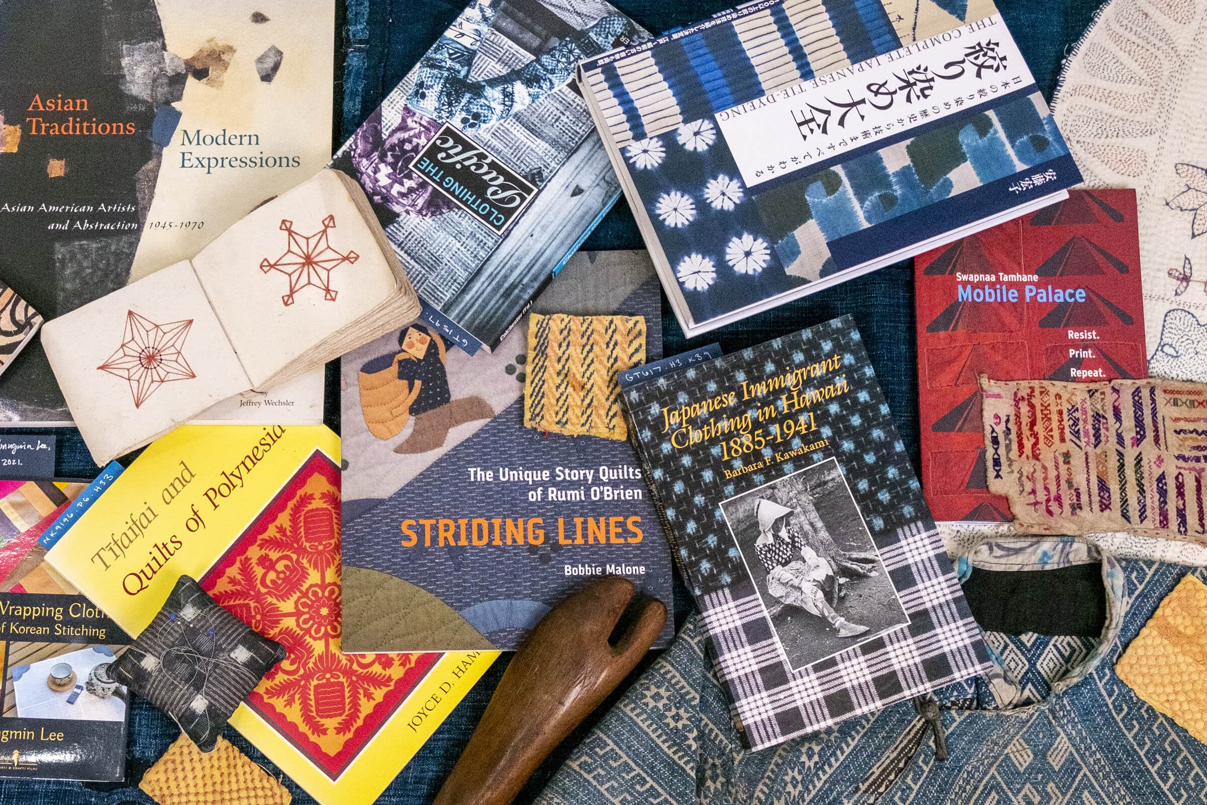 Assortment of books about textiles and quilting.