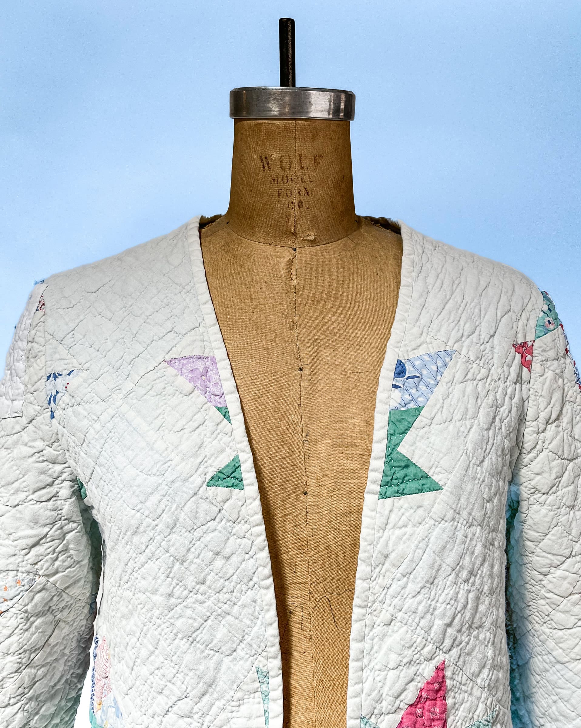 White quilted jacket with star pattern.