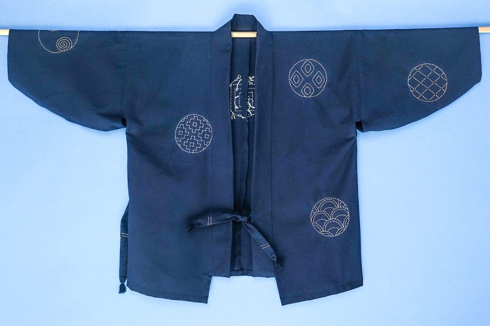 Blue Japanese kimono with white stitching.