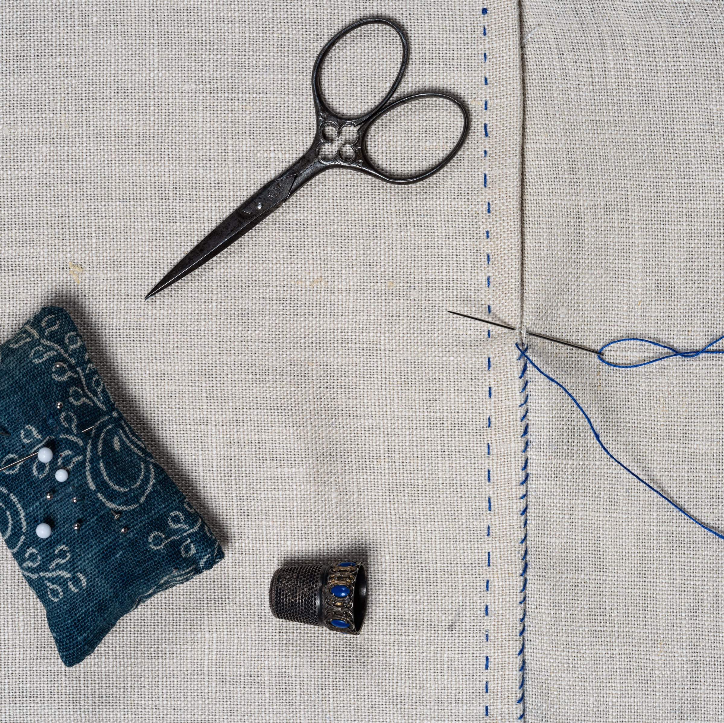 Sewing tools on a linen fabric.