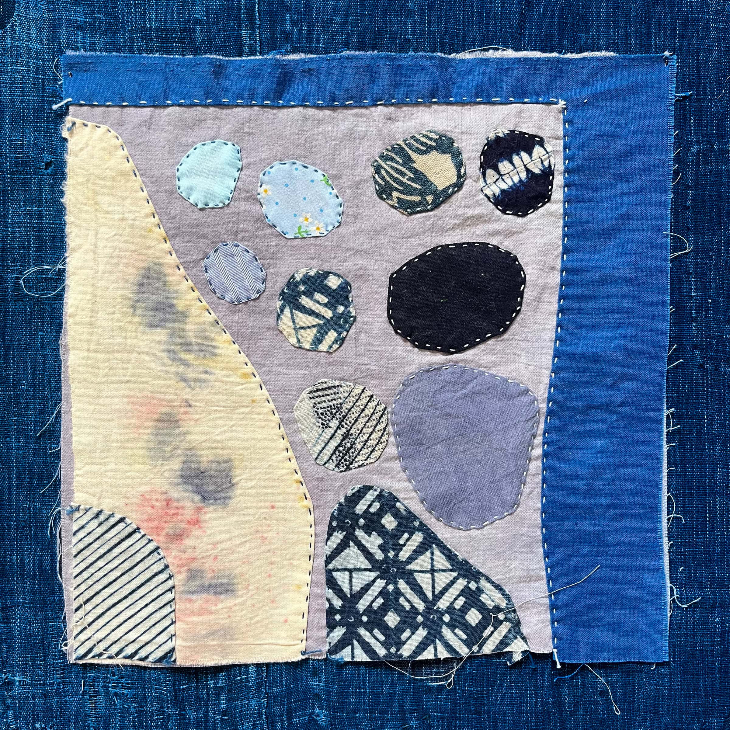 Patchwork fabric with blue border.