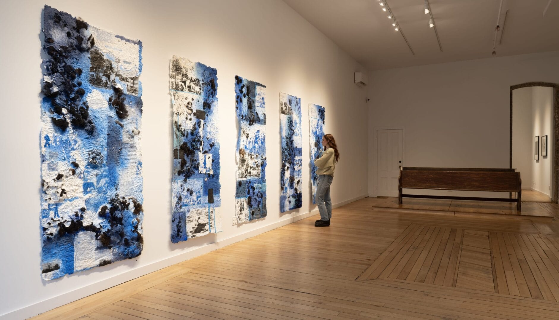 Blue and black abstract art in gallery.