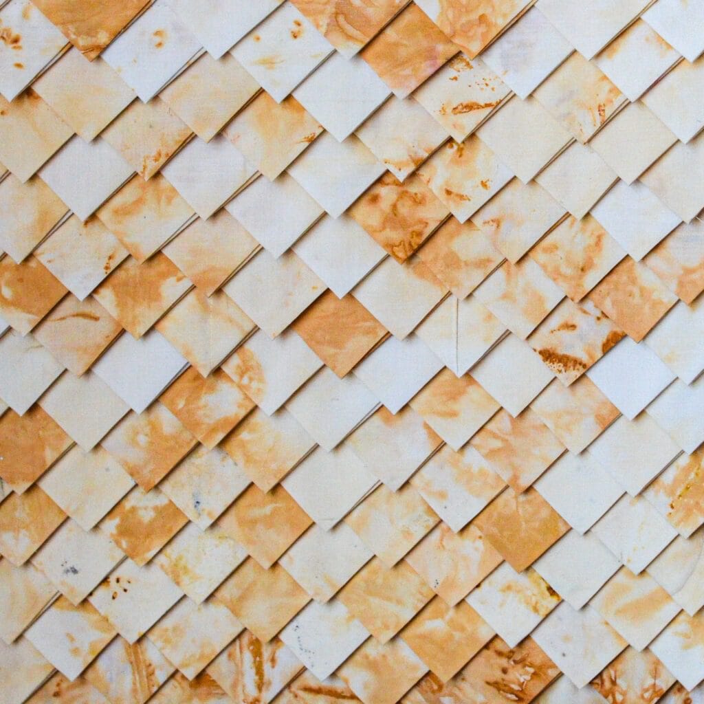 Pattern of overlapping, stained squares.
