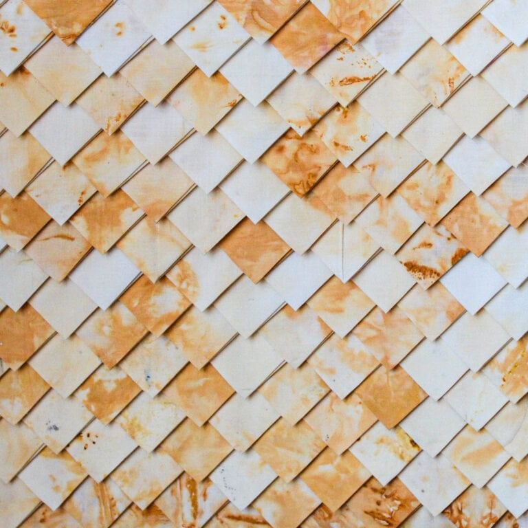 Pattern of overlapping, stained squares.