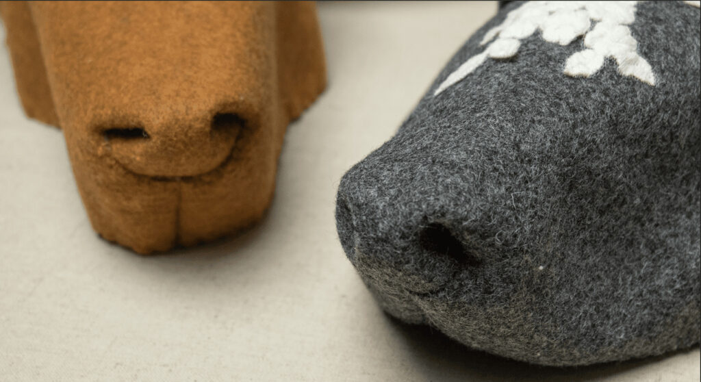 Two felt animal noses, brown and grey.