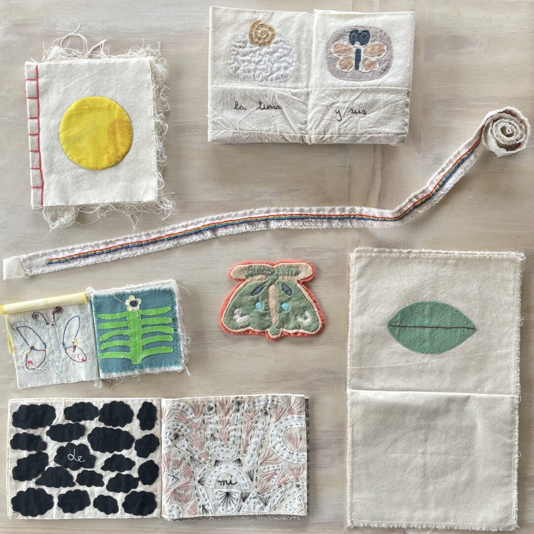 Fabric squares with embroidered designs.