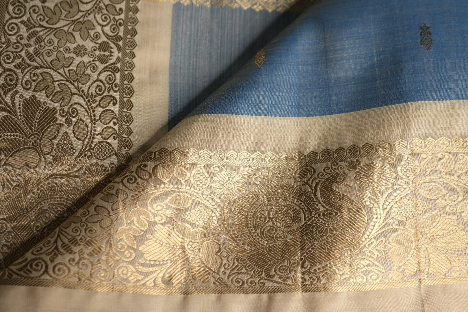 Beige fabric with gold floral patterns.