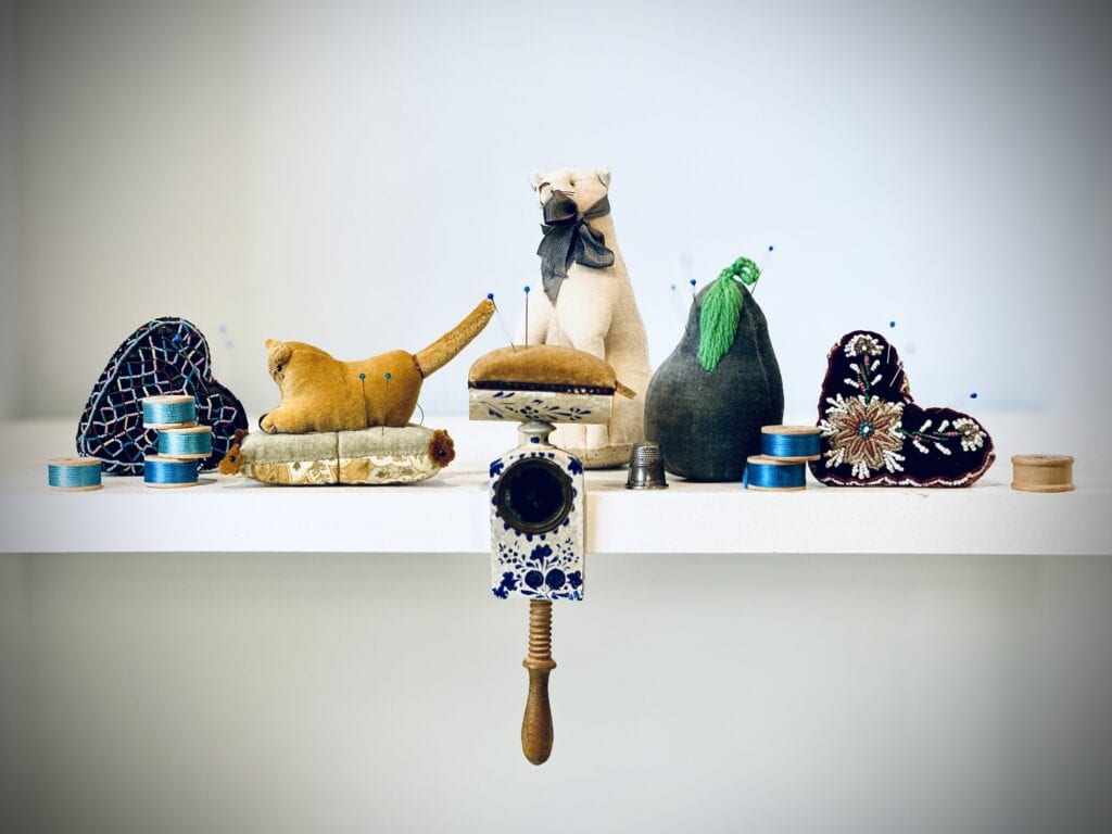 Vintage pincushions and sewing supplies.