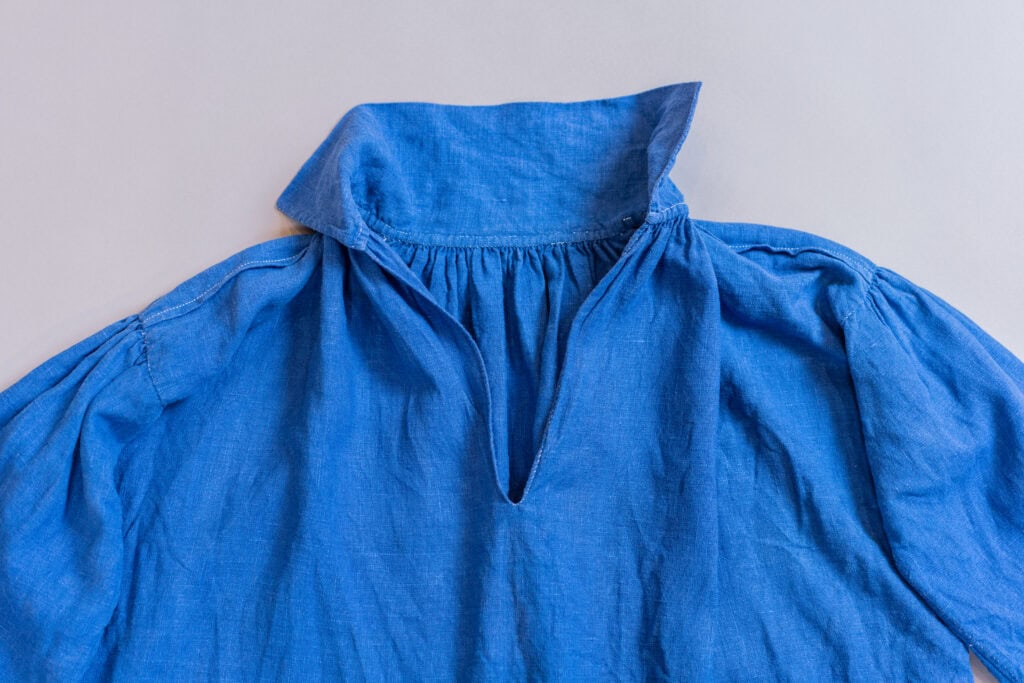 Blue linen shirt with a collar.