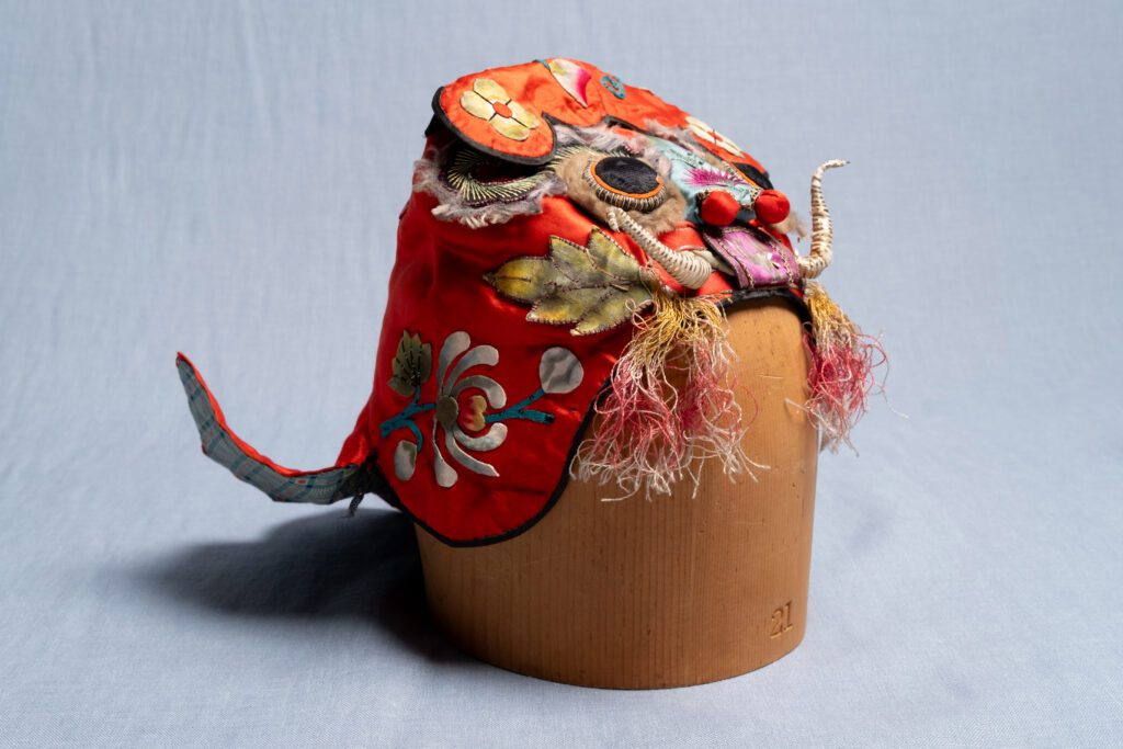 Red embroidered Chinese lion headdress.