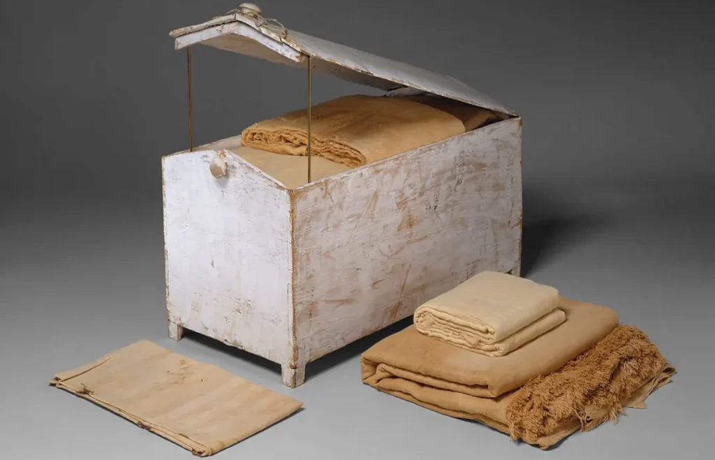 White wooden chest with fabric inside.