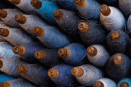 Close-up of blue and white thread spools.