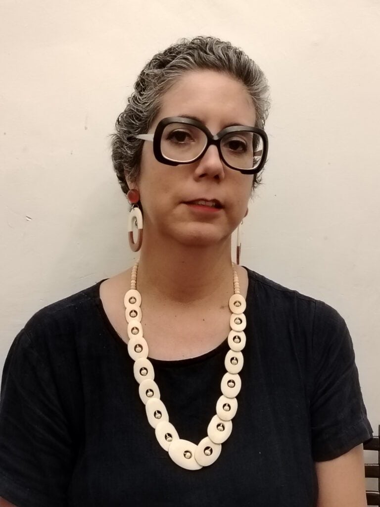 Woman with gray hair and a necklace.