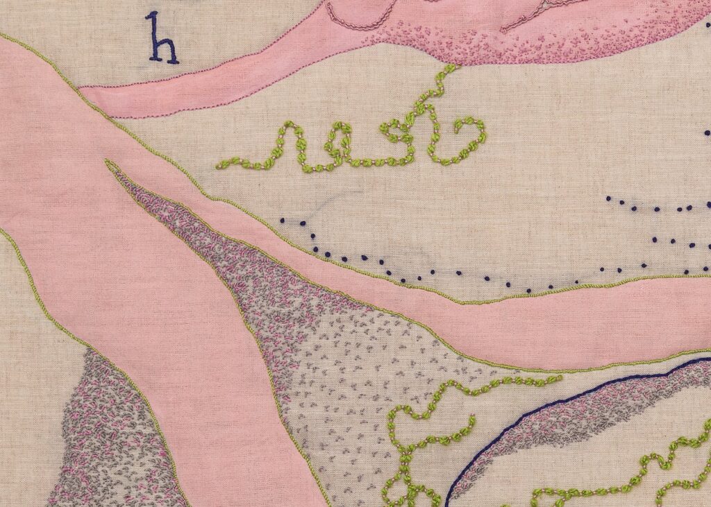 Embroidered abstract art with pink, green, and blue threads.