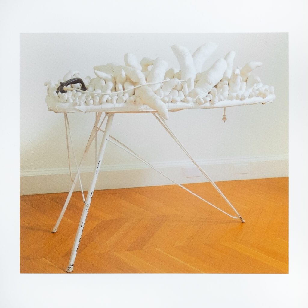 White sculpture on an ironing board.