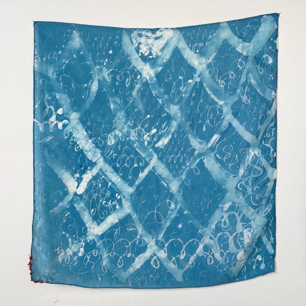 Blue and white patterned silk scarf.