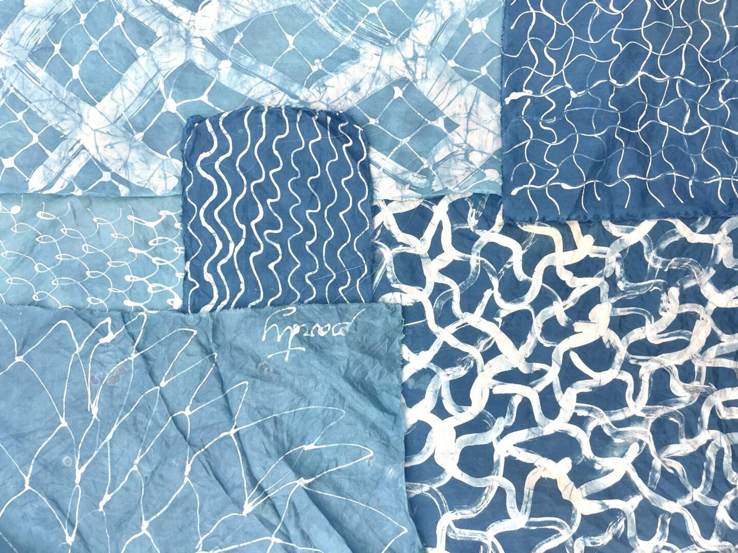 Blue fabric with white patterned designs.