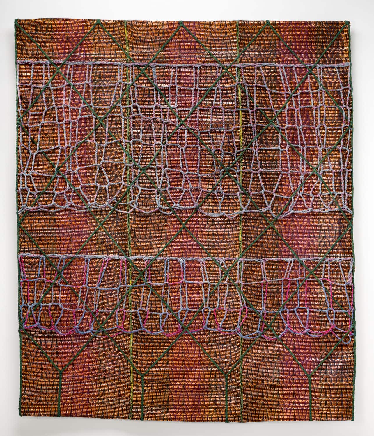 Green, blue and pink yarns intersecting over a handwoven ground of gold metal strips. Camille Ann Brewer, Valentine.
