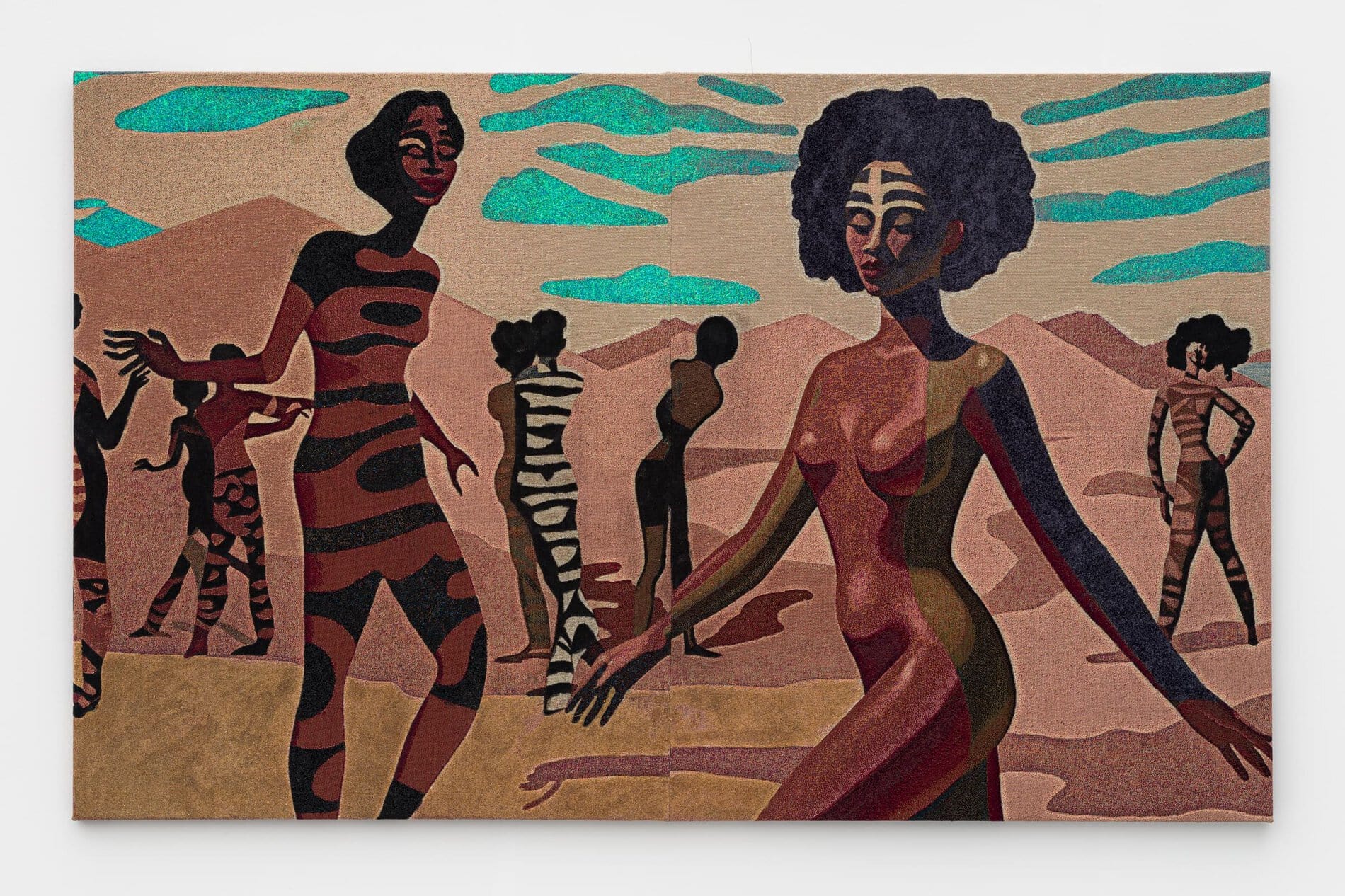 A tapestry depicting naked female figures with patterned bodies and/or faces positioned across a landscape of sand in front of mountains and a patterned turquoise sky.

