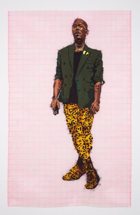 An embroidered portrait of a Black man wearing a double-breasted jacket, black shirt, and cheetah print pants.