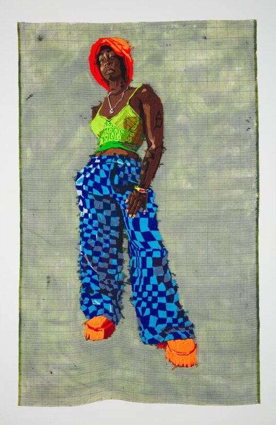 An embroidered portrait of Black woman wearing an orange hat, a green tank top, blue checkered pants, and orange shoes.

