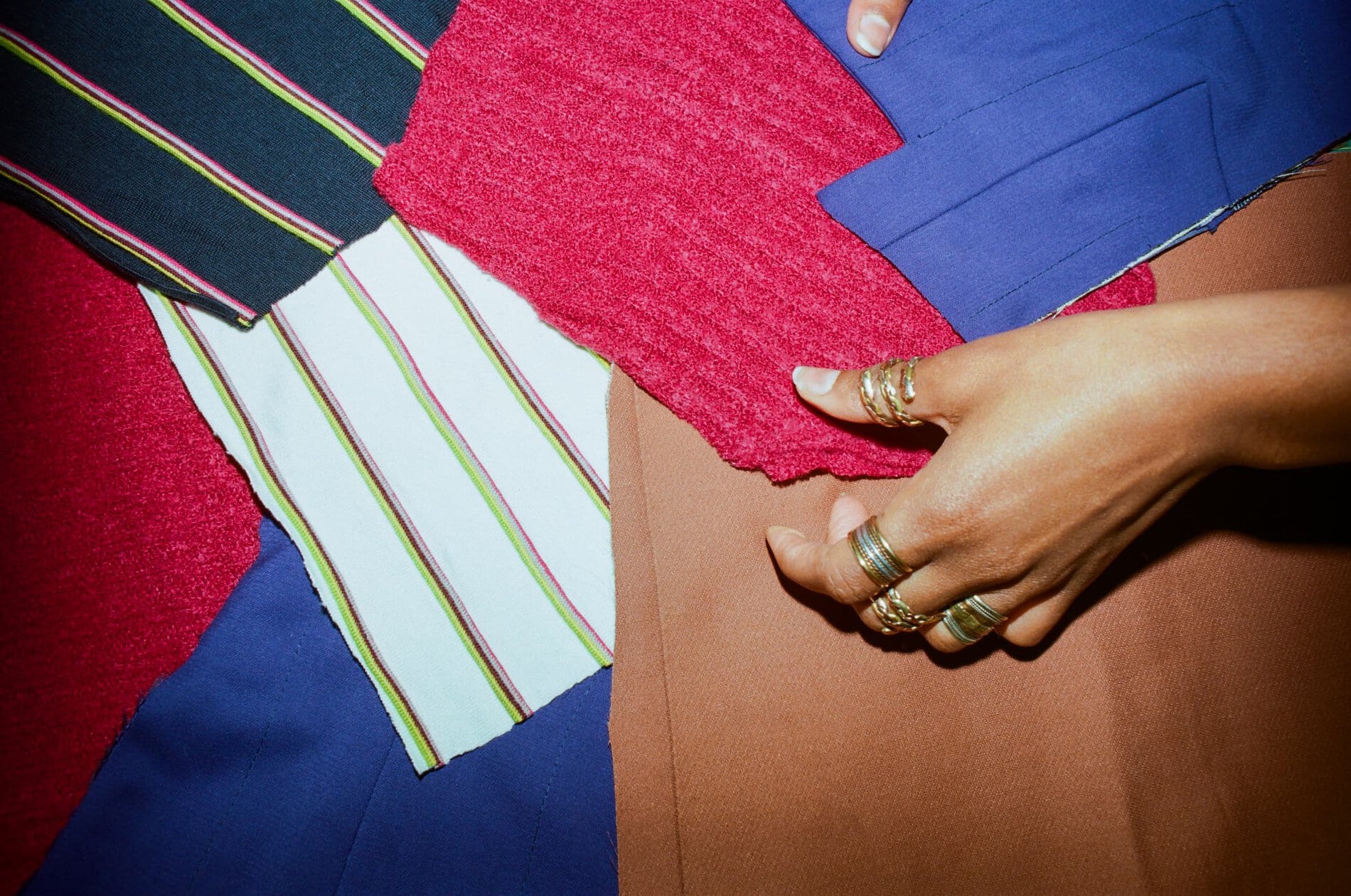 Patterned and solid fabrics of different colors layered on top of one another.
