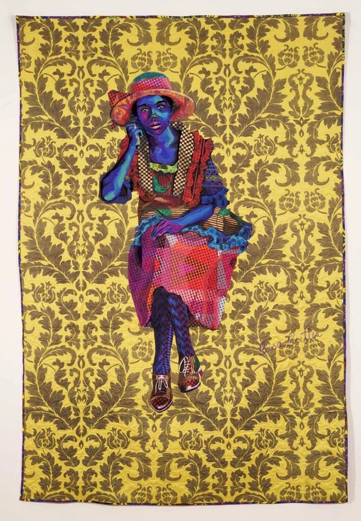 Quilted portrait of a seated Black woman in a colorful patterned skirt and blouse against a flourishing yellow patterned background. Bisa Butler, Daughter of the Dust.
