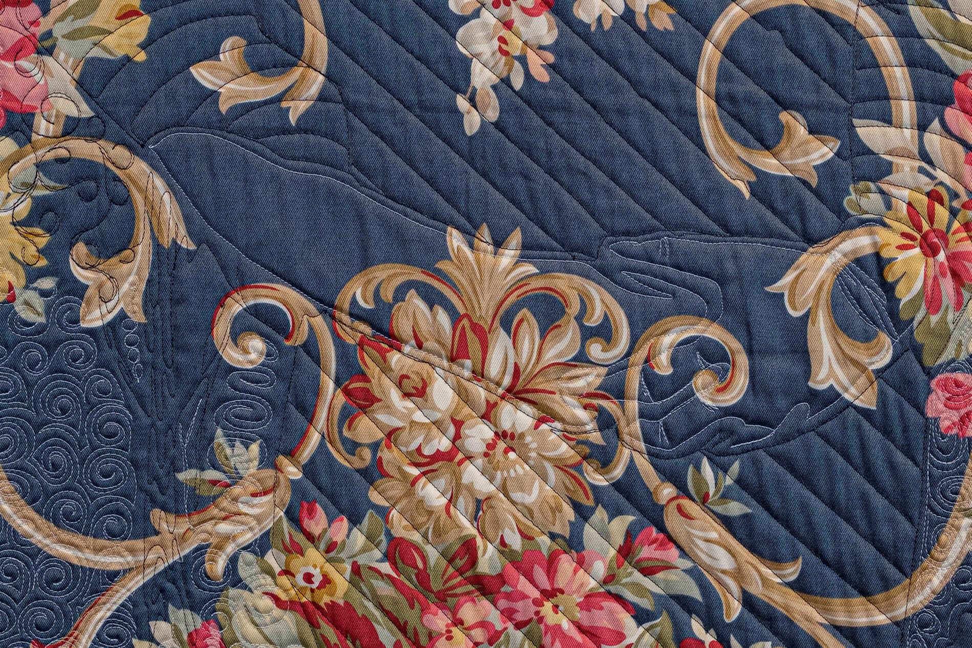 Up-close image of blue fabric with floral patterns.
