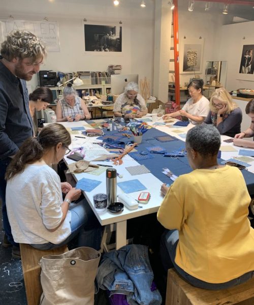 Group of people working on textiles.